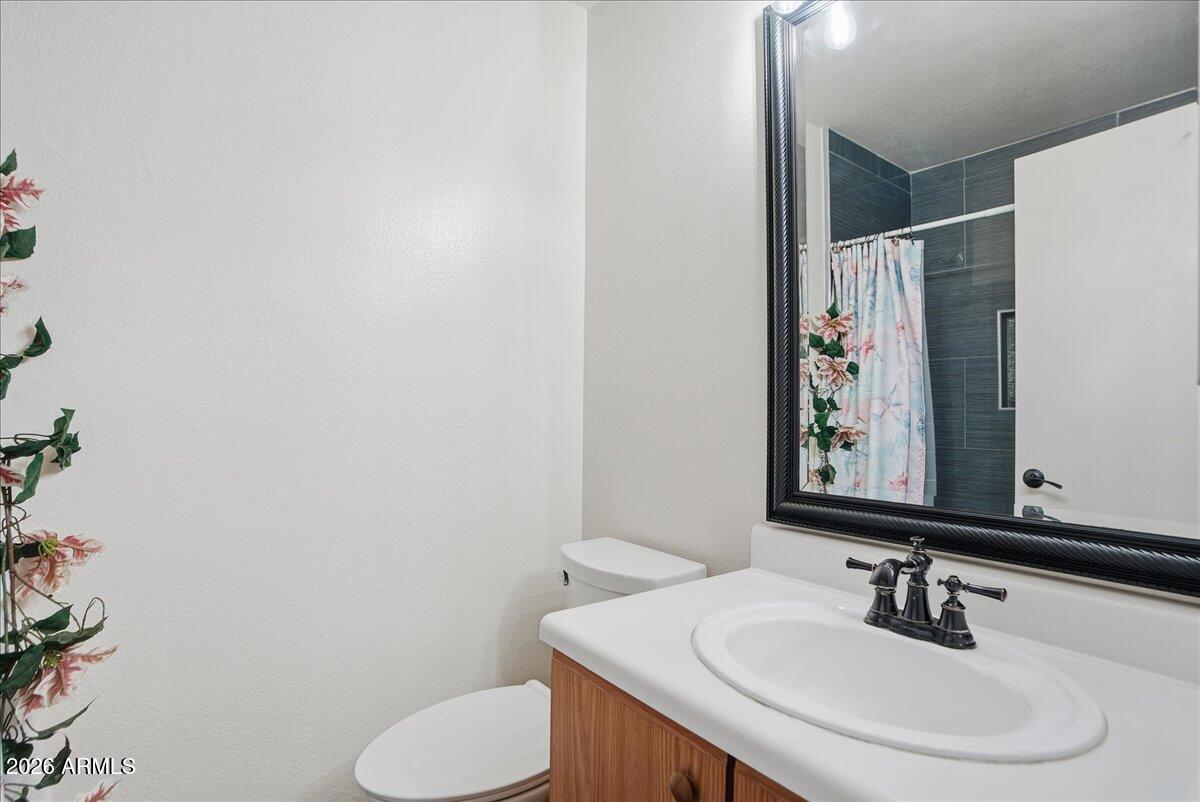 1825 West Renaissance Avenue Apache Junction, AZ 85120 - Photo 15 of 23 a bathroom with a sink and a mirror