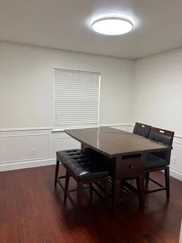 a view of a dining room with furniture and wooden floor