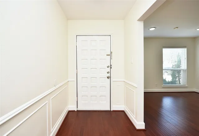 a view of a room with wooden floor