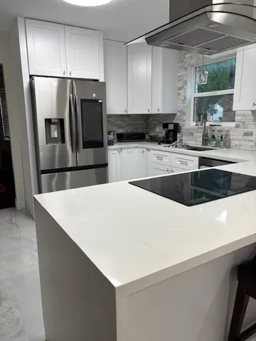 a kitchen with a refrigerator a sink and cabinets