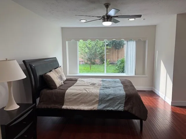 a bed sitting in a bedroom next to a window