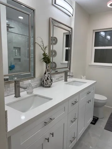 a bathroom with a double vanity sink and mirror