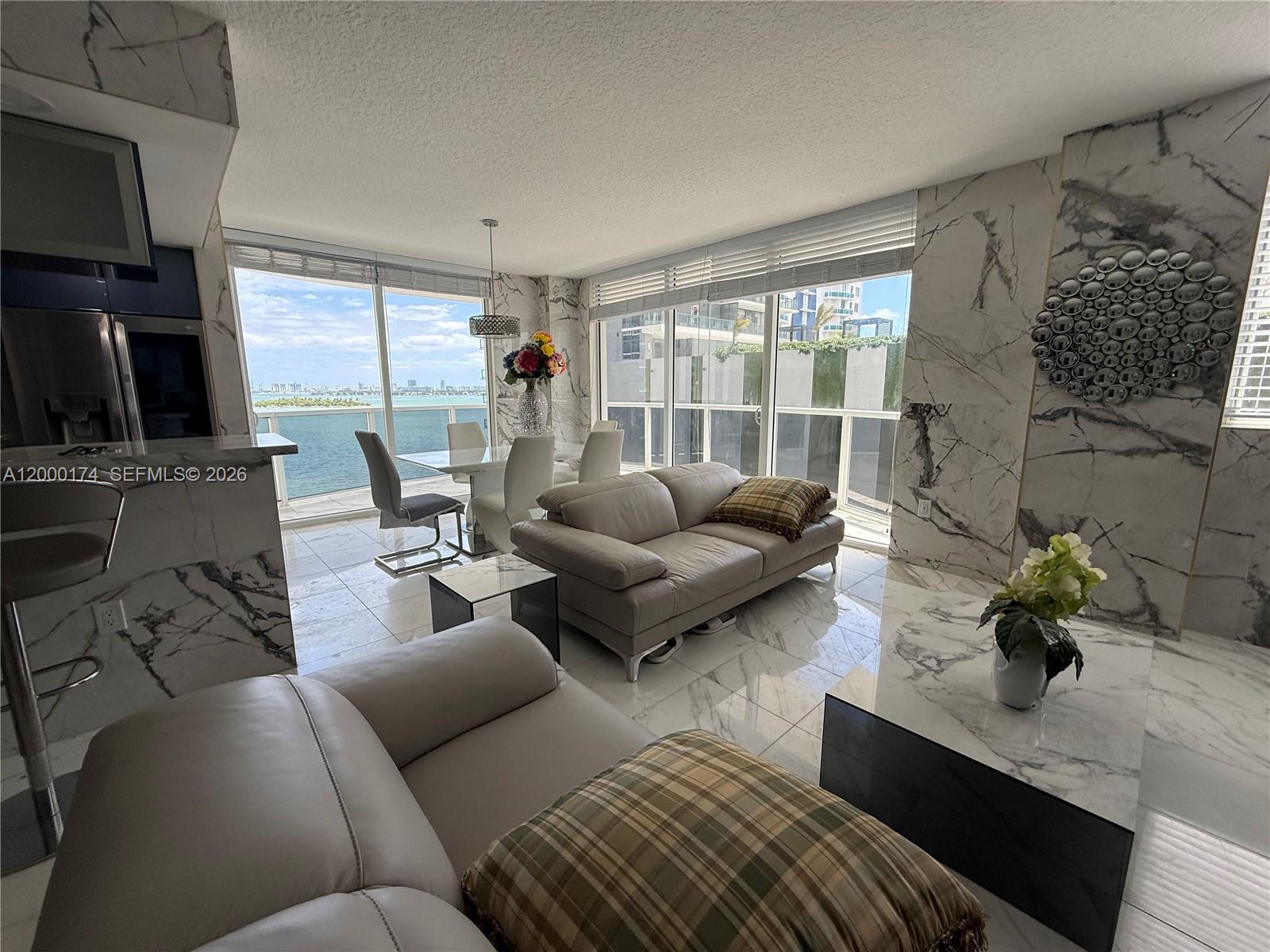601 Northeast 23rd Street, Unit 903 Miami, FL 33137 - Photo 11 of 61 a living room with furniture and a flat screen tv