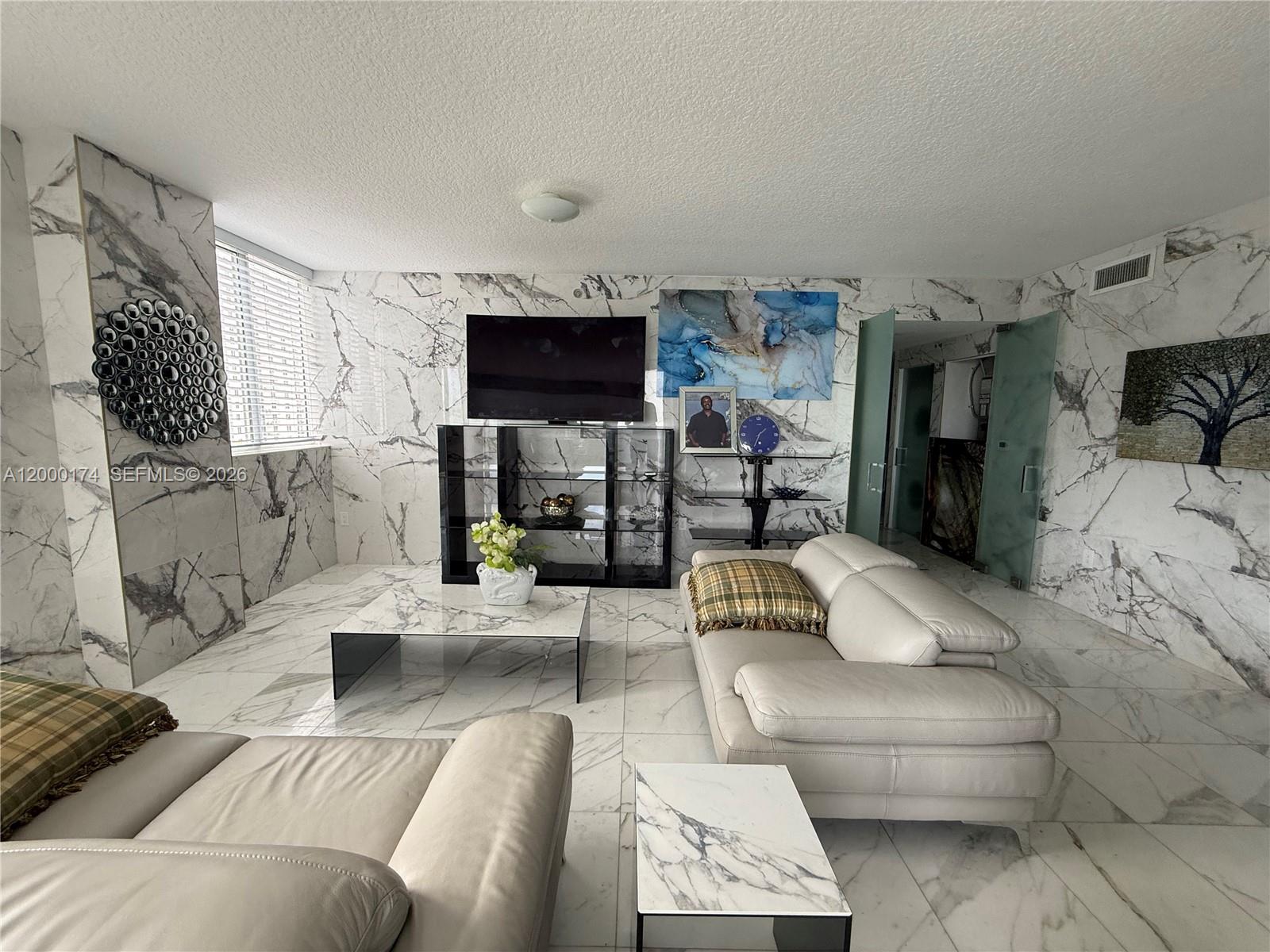 601 Northeast 23rd Street, Unit 903 Miami, FL 33137 - Photo 12 of 61 a living room with furniture and a flat screen tv