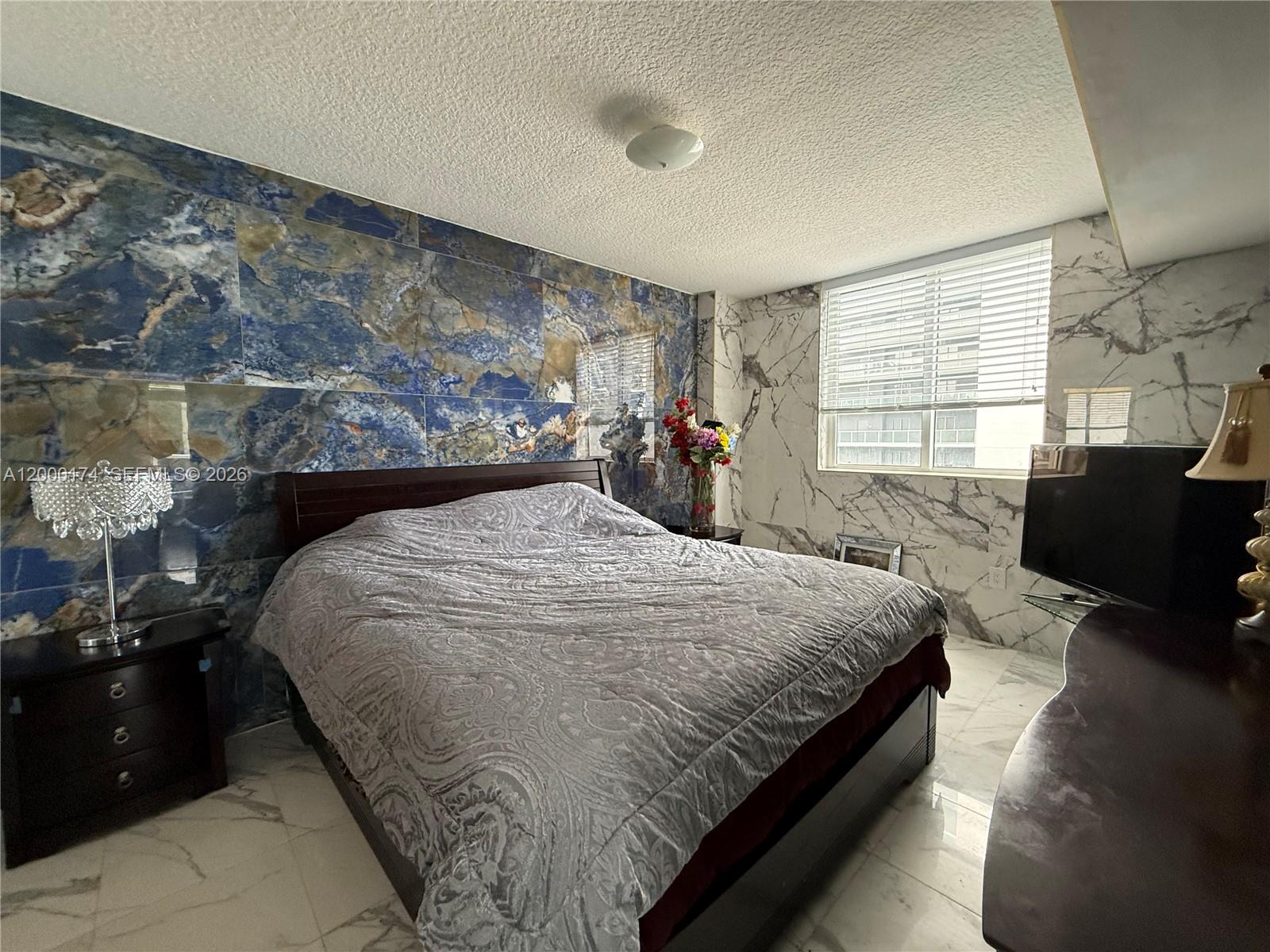 601 Northeast 23rd Street, Unit 903 Miami, FL 33137 - Photo 13 of 61 a bed sitting in a spacious bedroom next to a window