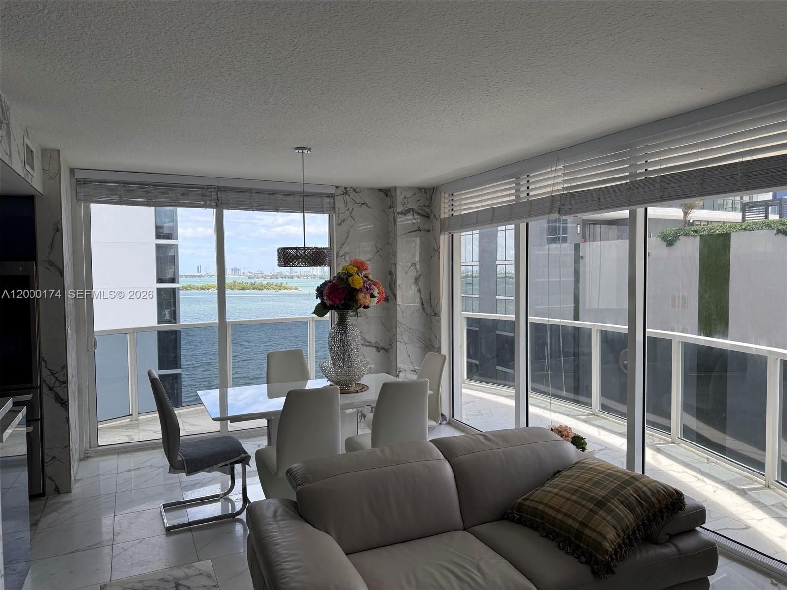 601 Northeast 23rd Street, Unit 903 Miami, FL 33137 - Photo 3 of 61 a living room with furniture and a floor to ceiling window