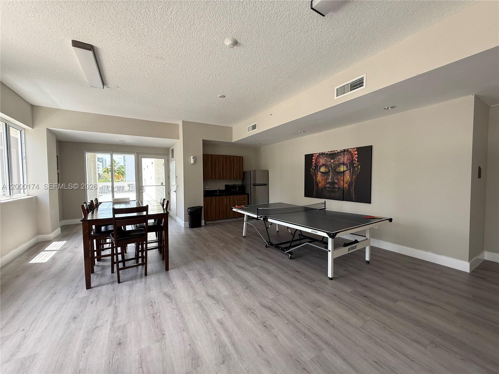 601 Northeast 23rd Street, Unit 903 Miami, FL 33137 - Photo 49 of 61 a living room with furniture a dining table and wooden floor