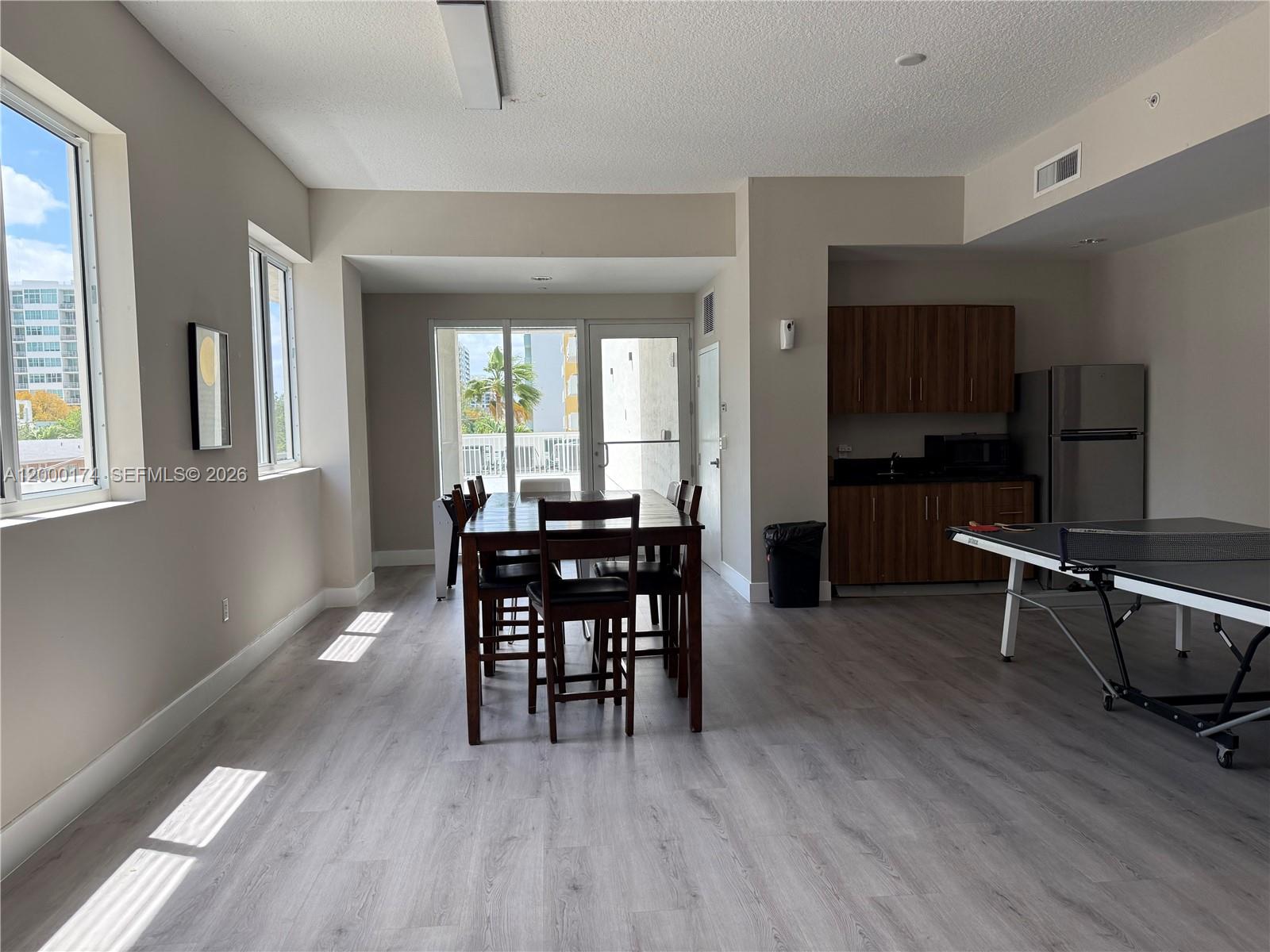 601 Northeast 23rd Street, Unit 903 Miami, FL 33137 - Photo 50 of 61 a view of a a dining room with furniture window and wooden floor