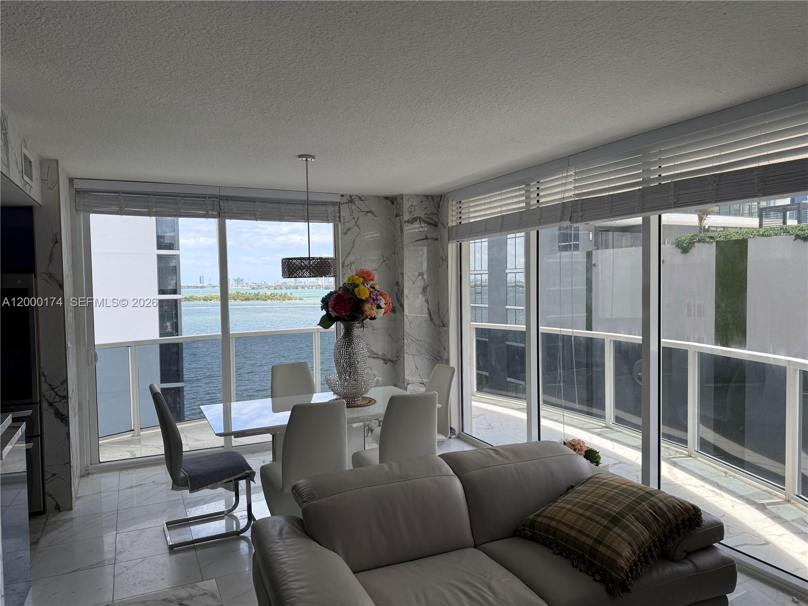 601 Northeast 23rd Street, Unit 903 Miami, FL 33137 - Photo 5 of 61 a living room with furniture and a floor to ceiling window