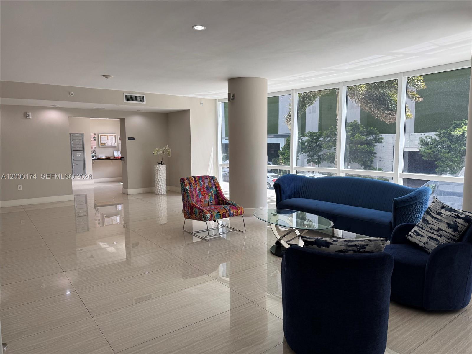 601 Northeast 23rd Street, Unit 903 Miami, FL 33137 - Photo 57 of 61 a living room with furniture and a floor to ceiling window