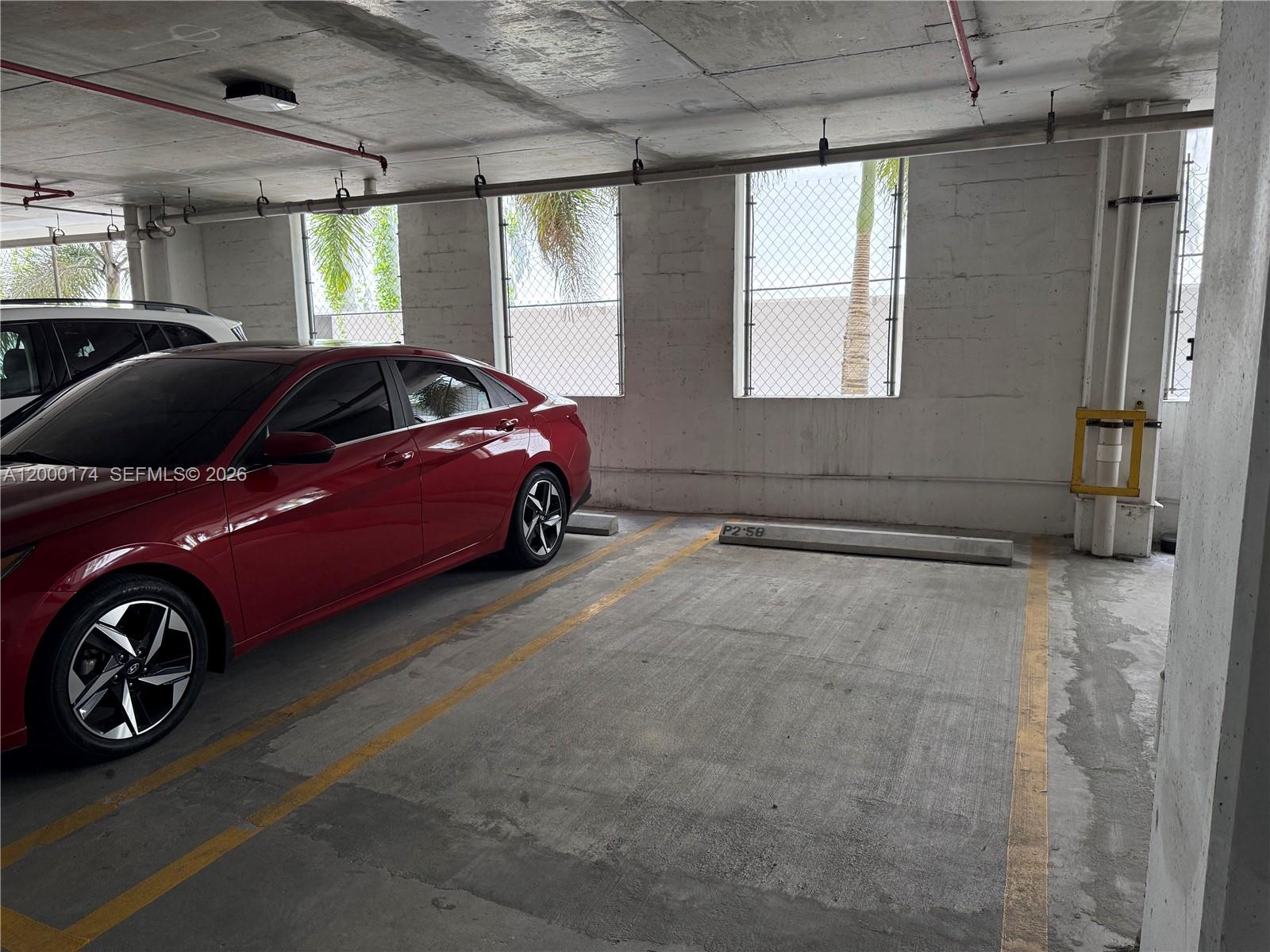 601 Northeast 23rd Street, Unit 903 Miami, FL 33137 - Photo 60 of 61 a car parked in a room next to a window