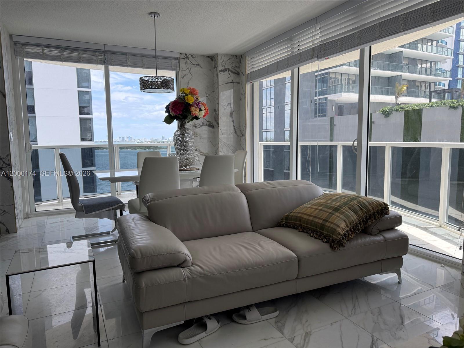 601 Northeast 23rd Street, Unit 903 Miami, FL 33137 - Photo 7 of 61 a living room with furniture and a floor to ceiling window