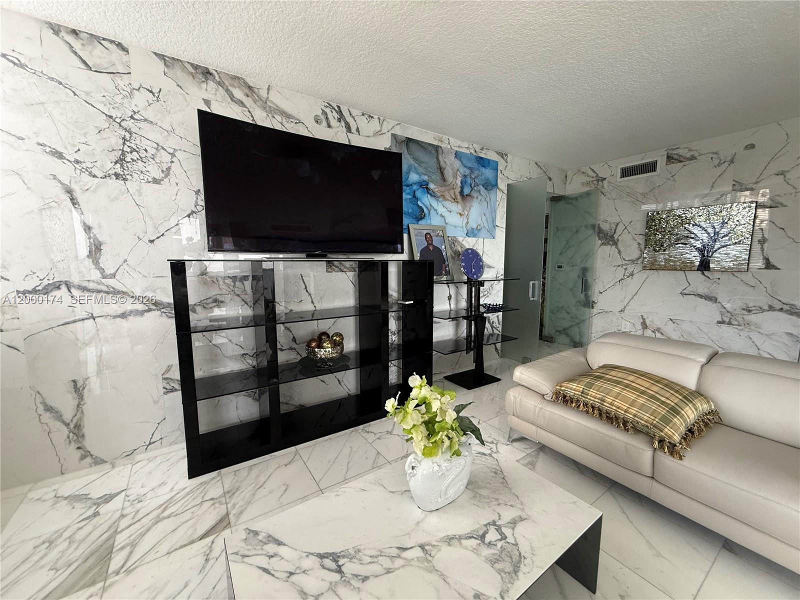 601 Northeast 23rd Street, Unit 903 Miami, FL 33137 - Photo 9 of 61 a living room with furniture and a flat screen tv