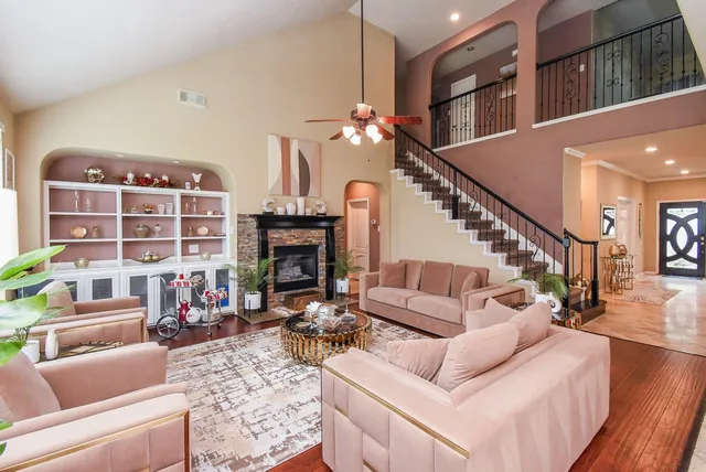 a living room with furniture a fireplace and a chandelier