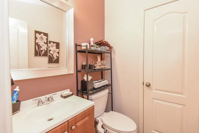 a bathroom with a sink a toilet and vanity