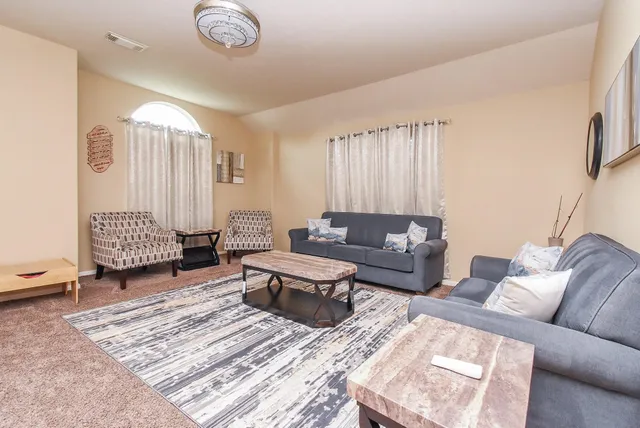 a living room with furniture and a lamp