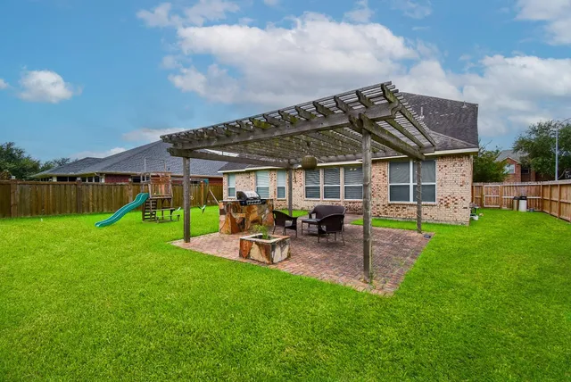 a view of a house with a backyard porch and sitting area