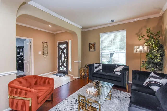 a living room with furniture and a potted plant