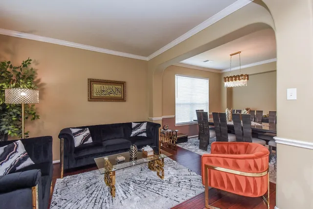 a living room with furniture and a dining table