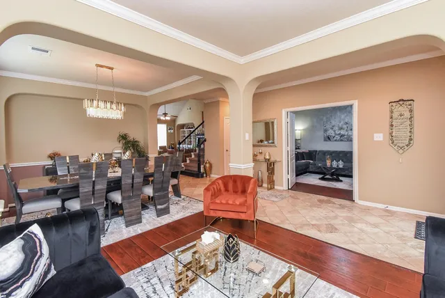 a living room with furniture and wooden floor