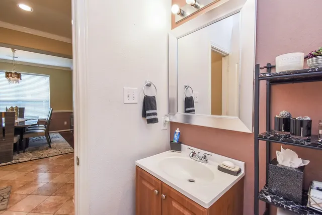 a bathroom with a sink vanity and a mirror