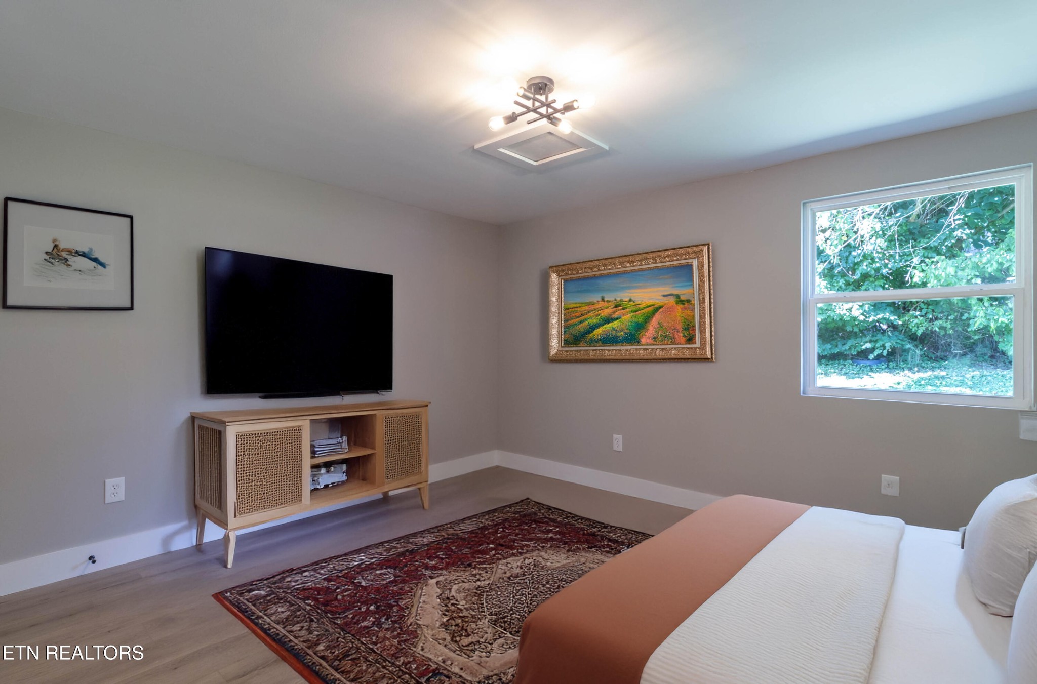 505 Foust Carney Road Powell, TN 37849 - Photo 27 of 40 a bedroom with a bed and a flat screen tv