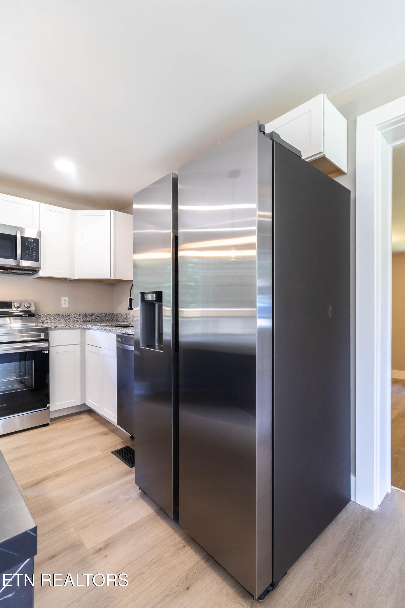 505 Foust Carney Road Powell, TN 37849 - Photo 8 of 40 a kitchen with granite countertop stainless steel appliances a refrigerator and a sink