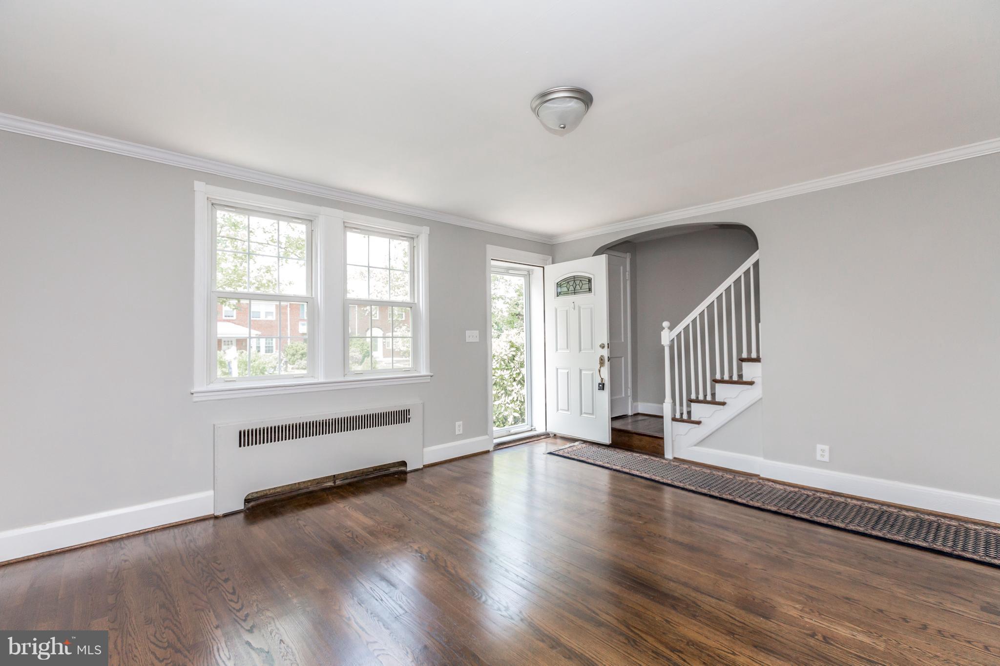7 Murdock Road Baltimore, MD 21212 - Photo 2 of 30 an empty room with wooden floor and windows