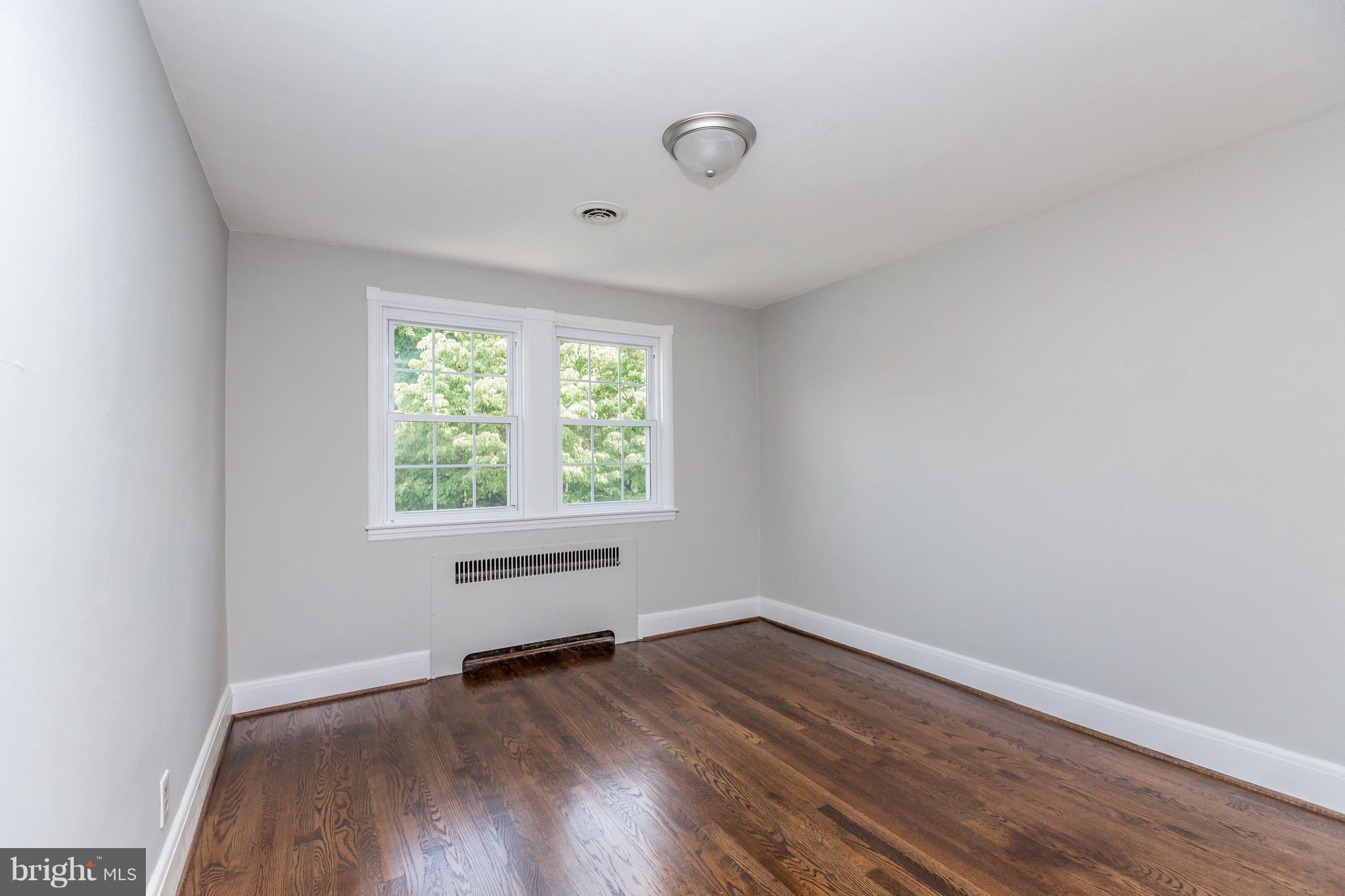 7 Murdock Road Baltimore, MD 21212 - Photo 13 of 30 an empty room with wooden floor and windows
