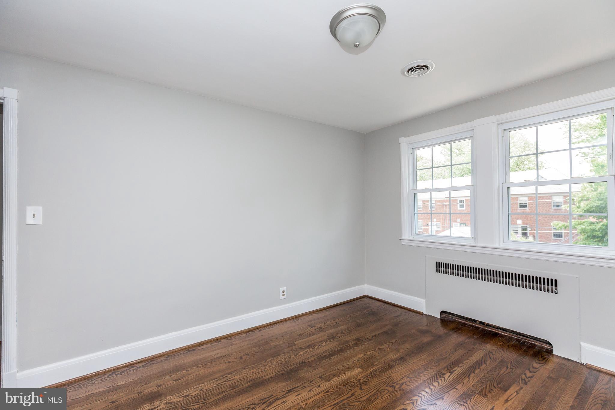 7 Murdock Road Baltimore, MD 21212 - Photo 14 of 30 an empty room with wooden floor and windows