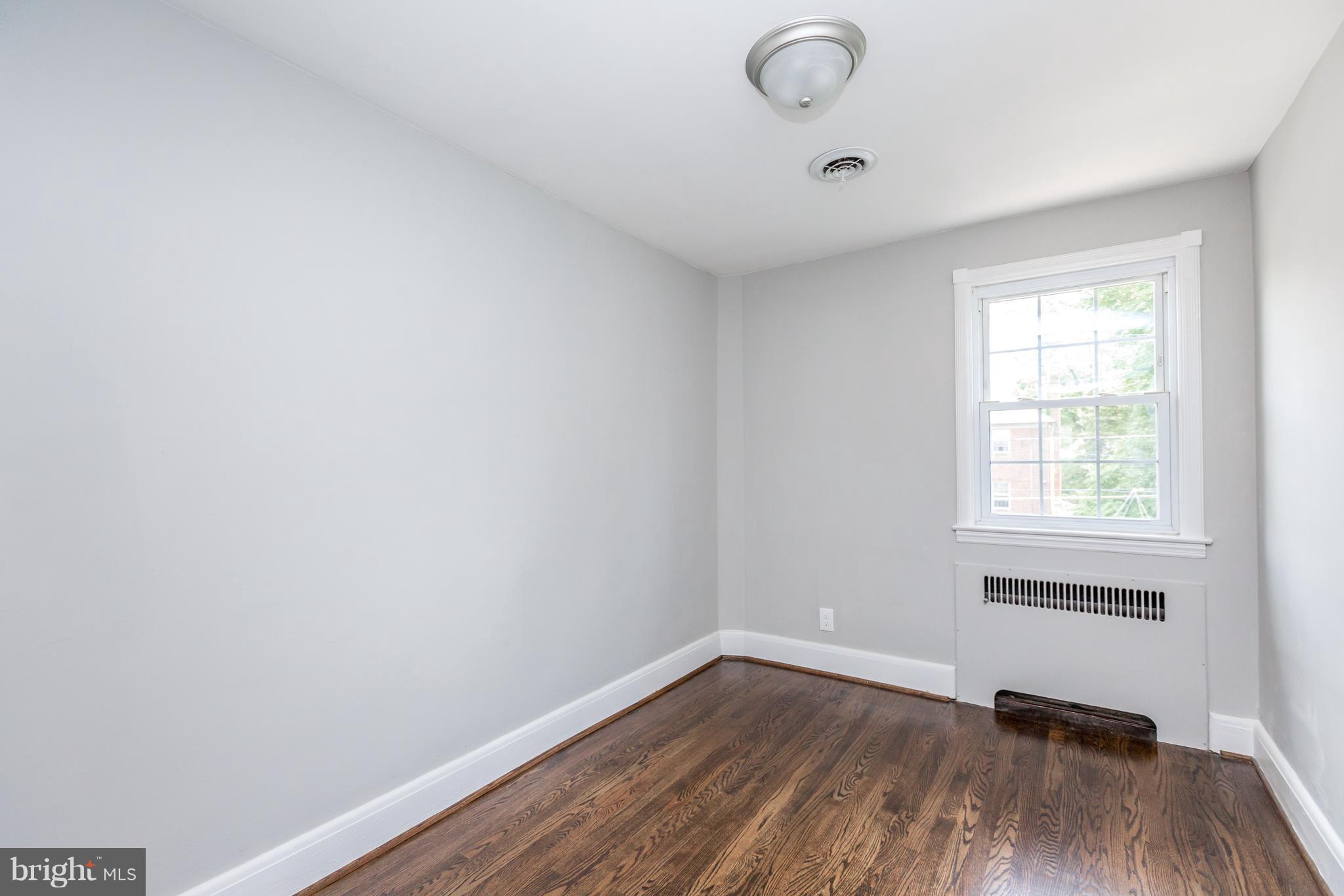 7 Murdock Road Baltimore, MD 21212 - Photo 17 of 30 an empty room with wooden floor and windows