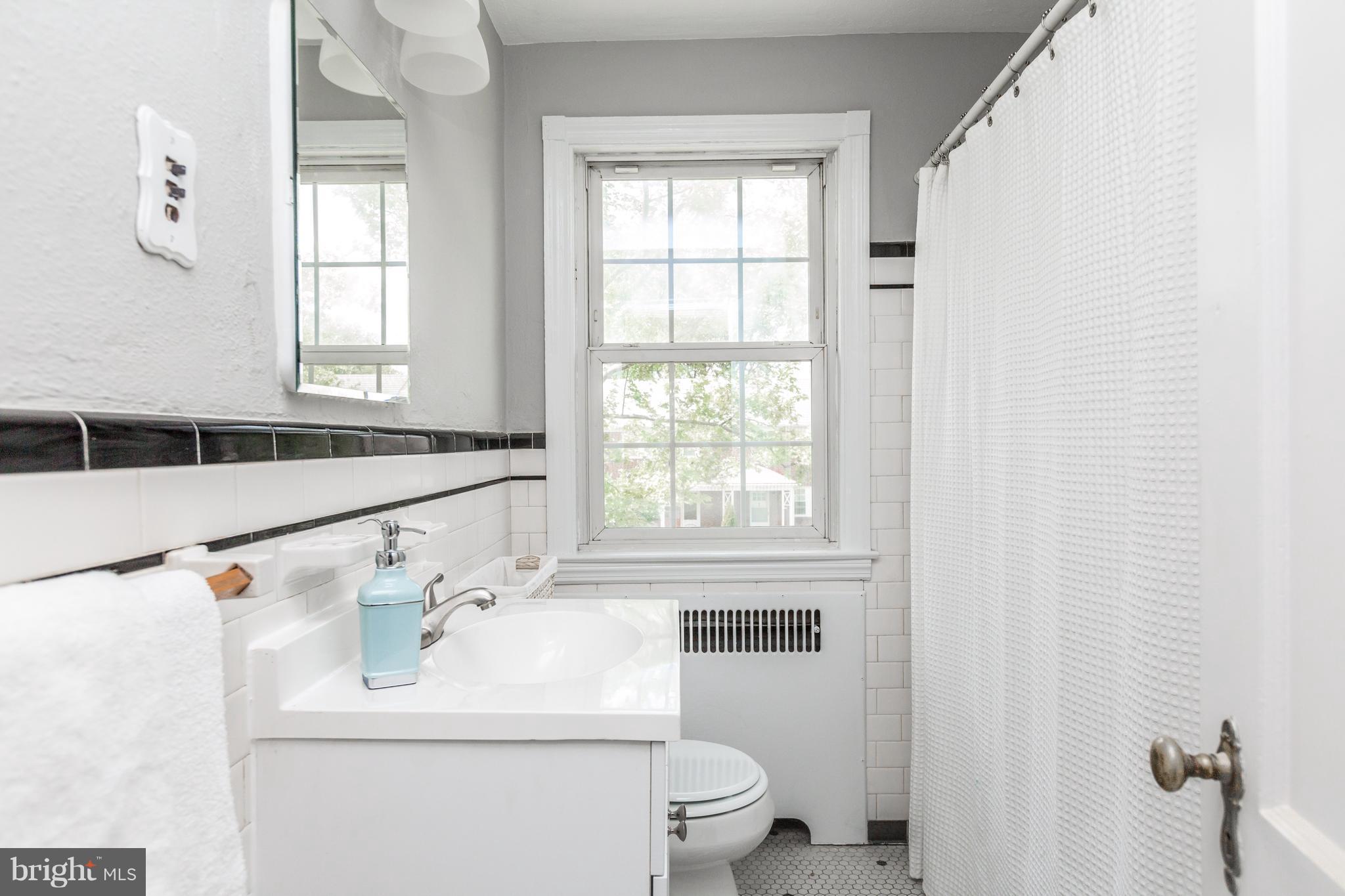 7 Murdock Road Baltimore, MD 21212 - Photo 20 of 30 a bathroom with a sink a toilet and a window