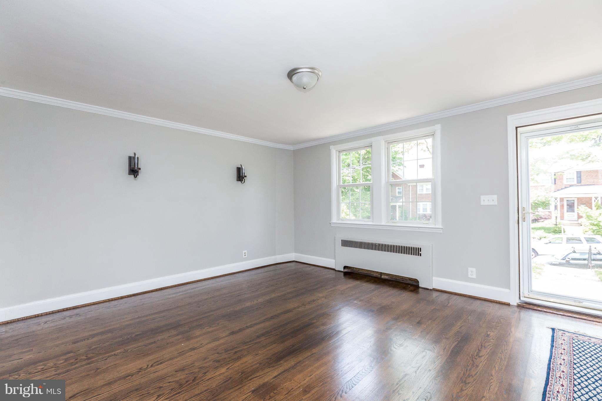 7 Murdock Road Baltimore, MD 21212 - Photo 3 of 30 an empty room with wooden floor and windows