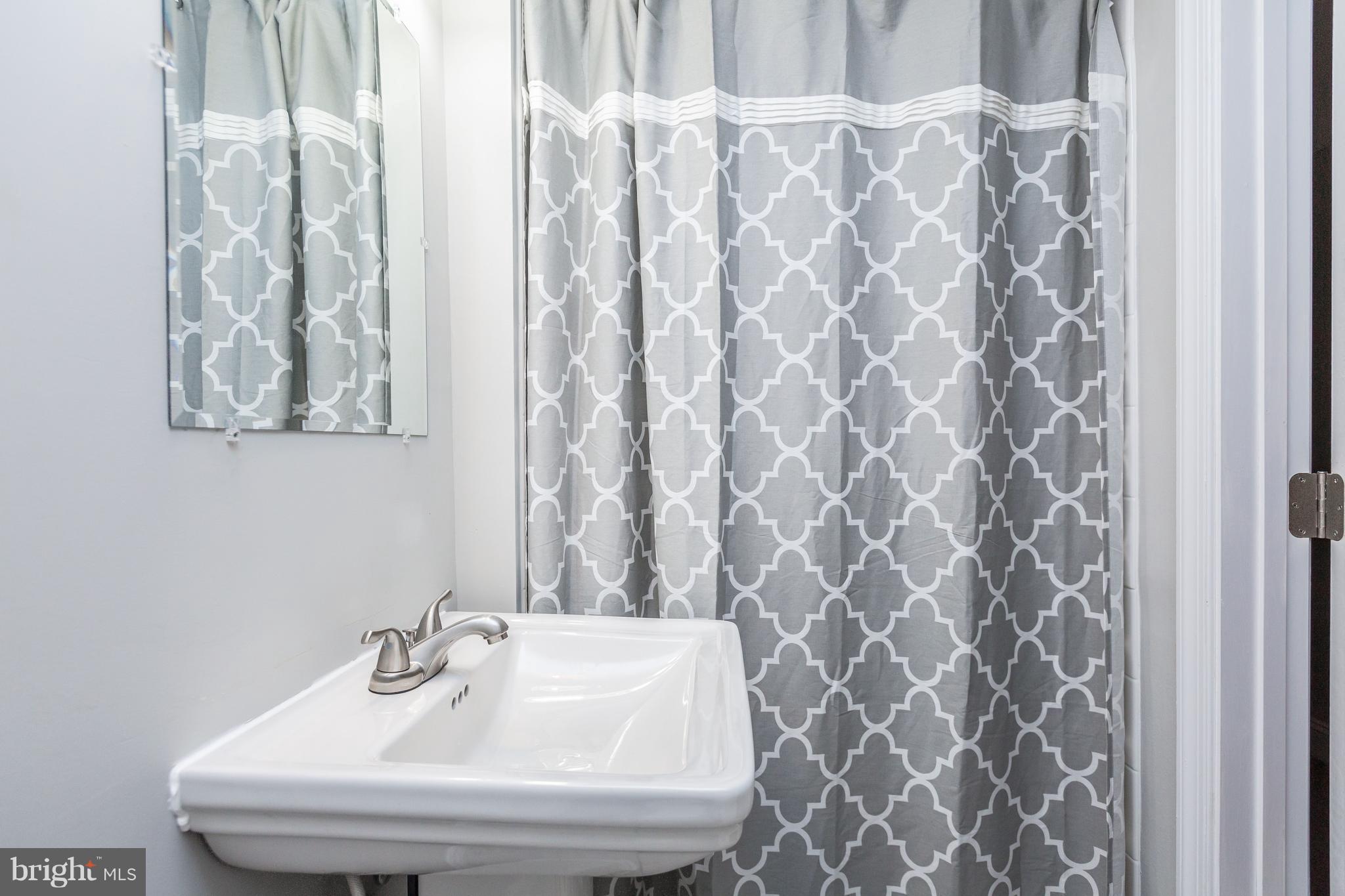 7 Murdock Road Baltimore, MD 21212 - Photo 27 of 30 a bathroom with a sink and a mirror