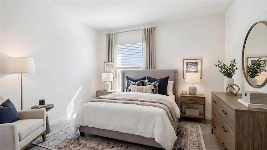 4706 Kona Circle Spring Hill, FL 34608 - Photo 11 of 18 a bedroom with bed and a couch