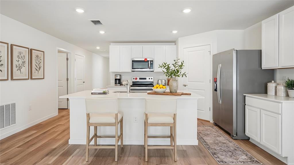 4706 Kona Circle Spring Hill, FL 34608 - Photo 4 of 18 a kitchen with stainless steel appliances a refrigerator and a stove top oven