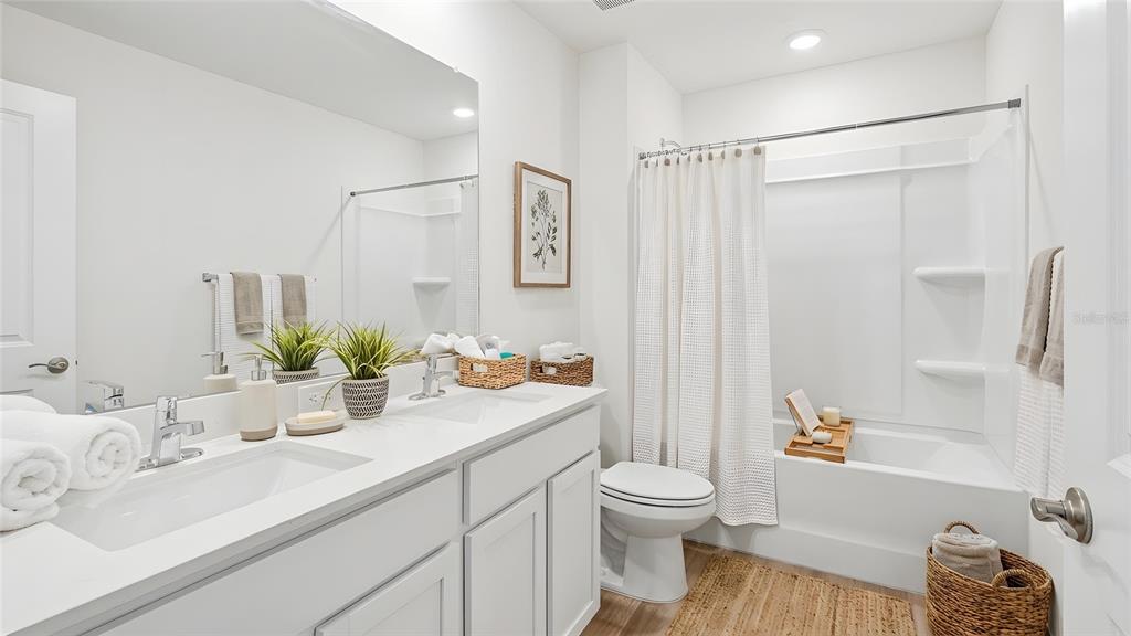 4706 Kona Circle Spring Hill, FL 34608 - Photo 9 of 18 a bathroom with a sink a toilet and a large mirror