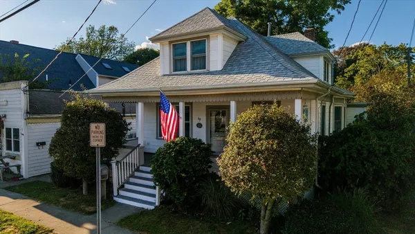 a front view of a house with plants