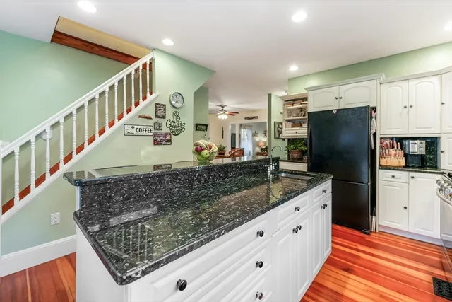a kitchen with stainless steel appliances granite countertop a refrigerator and a sink