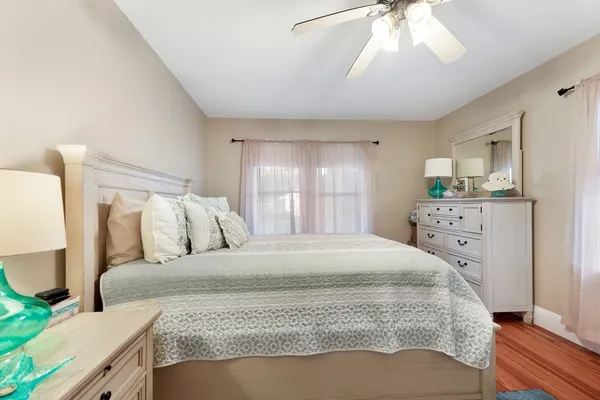 a bedroom with a large bed and a chandelier