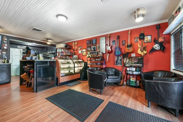 a room with lots of wooden furniture and a book shelf