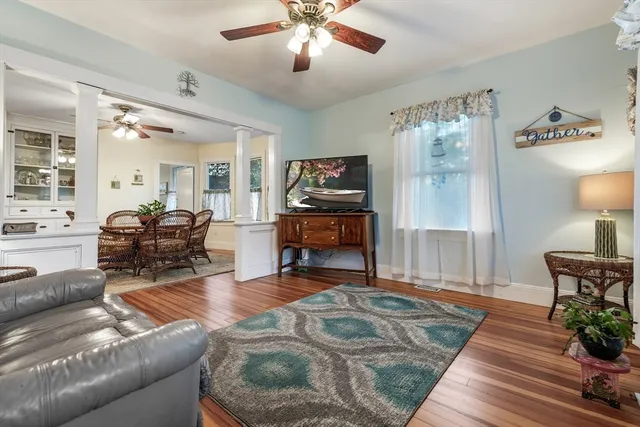 a living room with furniture and wooden floor