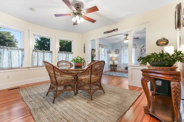 a view of a dining room with furniture window and wooden floor