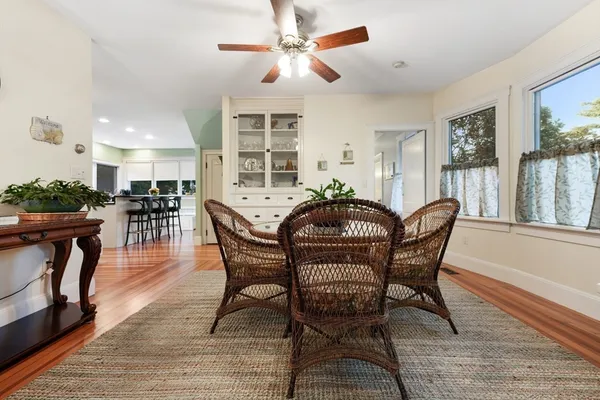a dining room with furniture window and wooden floor