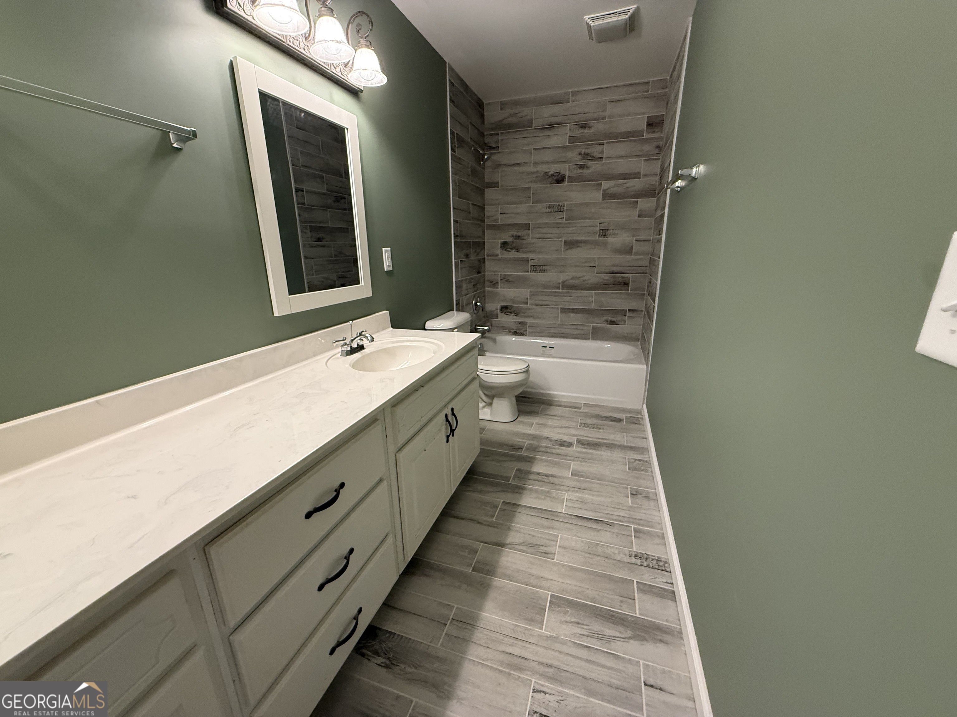 240 Sims Street Barnesville, GA 30204 - Photo 9 of 25 a bathroom with a double vanity sink and mirror