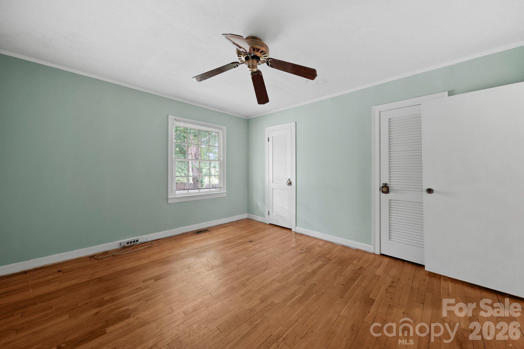 1109 Union Road Gastonia, NC 28054 - Photo 16 of 44 a view of an empty room with wooden floor and a window