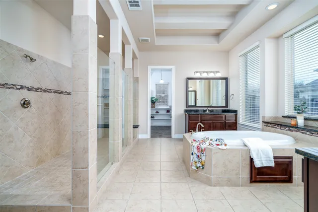 a bedroom with a bed and large mirror