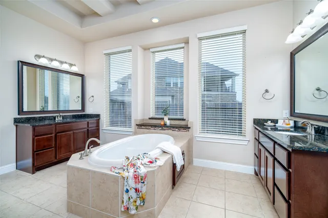 a spacious bedroom with a bed and a dresser