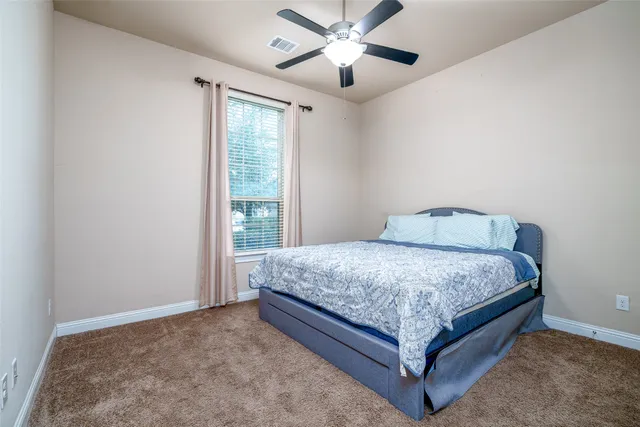 a spacious bedroom with a bed and window