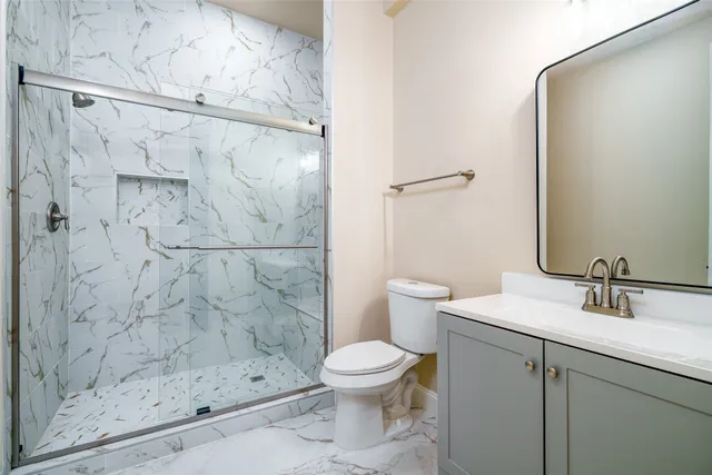 a bathroom with a shower and a toilet